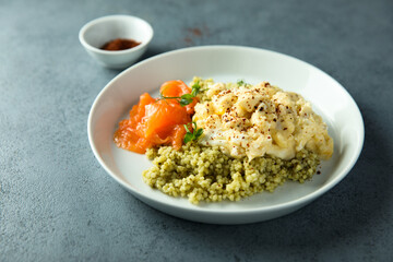 Scrambled eggs with couscous and smoked salmon
