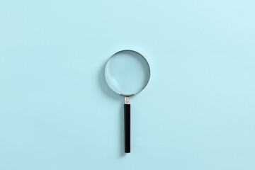 Magnifying glass or magnifier on blue background