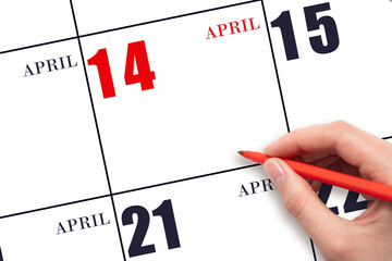 A hand holding a red pen and pointing on the calendar date April 14. Red calendar date, copy space, mockup.