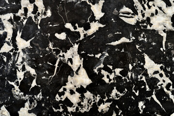 Detail of black and white marble stone table over one hundred years old. Close-up. Top view.