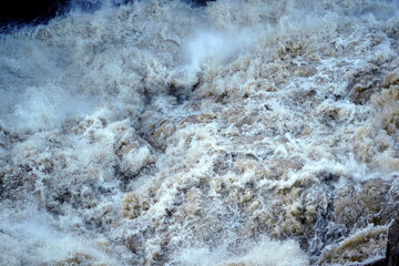Fototapeta na wymiar Torrential river waters in a flood
