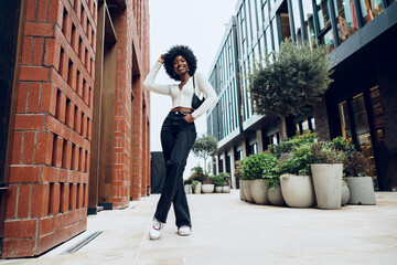 Portrait of attractive young woman walking outside in the city © fotofabrika