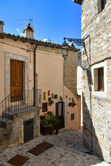 A narrow street between the old stone houses of Barrea, a medieval village in the Abruzzo region of Italy.