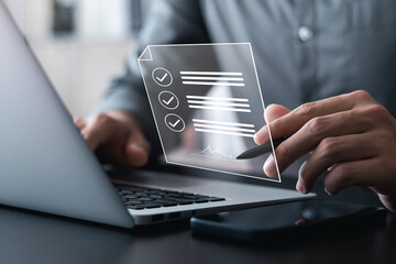 Electronic signature concept, business man using stylus pen to approve digital document on screen like using stylus pen, paperless office Signing future business contracts.
