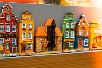 Rows of fridge magnet souvenirs from Gdansk displayed on stillage. Model houses magnets on display in Gdansk Poland travel destination concept in city market square