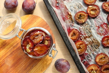 plum dried in the oven with spices and garlic for harvesting for the winter in jars delicacy