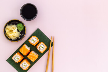 Sushi rolls set with salmon on green papper plate