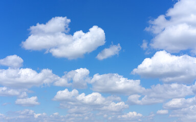 Fototapeta na wymiar Clear blue sky background with white clouds