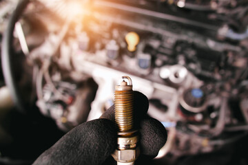 Close up of car iridium spark plugs damaged by heavy use of the car engine ignition system, engine...