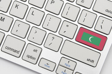 national flag of maldives on the keyboard on a grey background .3d illustration
