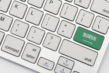 national flag of saudi arabia on the keyboard on a grey background .3d illustration