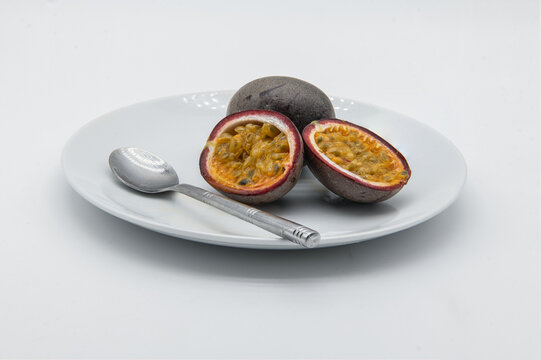 Passion fruit on a white plate.