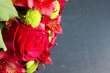 Vibrant color beautiful red rose in bouquet with water drops in the bunch close up with copyspace