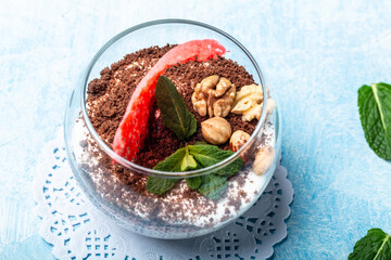 dessert tiramisu in a glass on a blue background, Traditional unbaked italian dessert, Copy space
