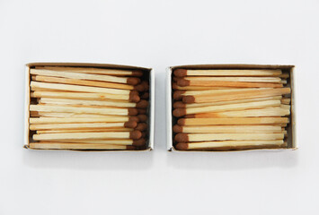 yellow wooden matches with a sulfur head in a cardboard box on a white background