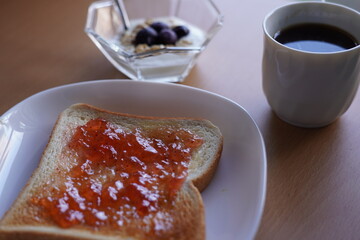 Jam toast, yogurt and black coffee, breakfast