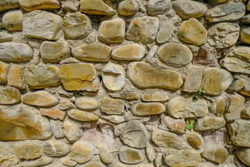 Modern yellow stone brick wall background close-up. Copy space. Natural. Building exterior	