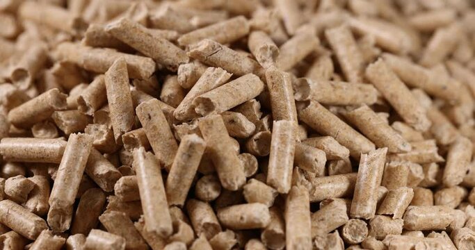 closeup of wood pellets rotation. biomass energy