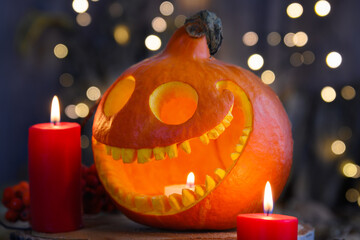 Smiling pumpkin lantern with candles and bokeh Halloween concept