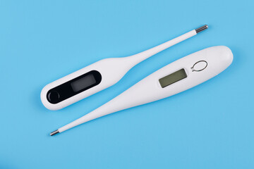 Temperature Measurement electronic device. Digital Thermometer isolated on blue background. medical diagnostic and healthcare concept