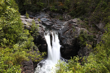 Fototapeta na wymiar Moving water effect at Chute Sainte Anne waterfalls, Gaspesie NP, Quebec
