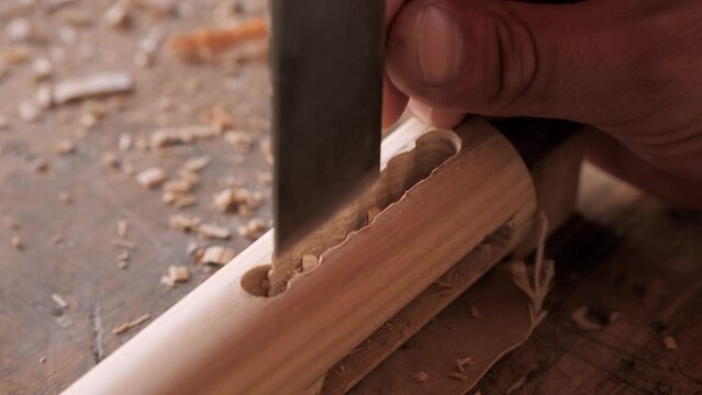 woodworker with chisel makes mortise and tenon 