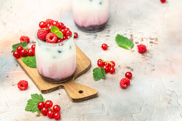 Raspberry dessert cheesecake, trifle, mouse in a glass. Raspberry Greek yogurt granola parfait on a light background. Restaurant menu, dieting, cookbook recipe