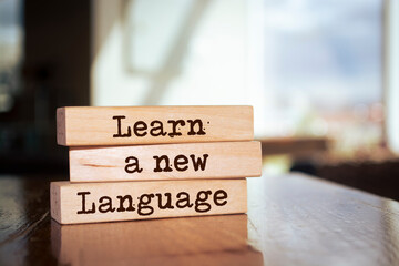 Wooden blocks with words 'Learn A New Language'.
