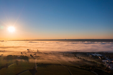 Obraz premium Aerial view of a beautiful sunrise in autumn over the Rhine in the morning mist near Eltville/Germany