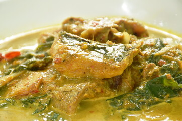 spicy spicy slice stingray fish in coconut milk curry on plate