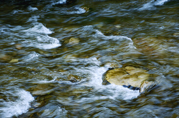 dark autumn river with stones