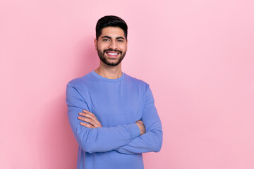 Photo of confident attractive arab guy dressed blue pullover arms crossed empty space isolated pink...
