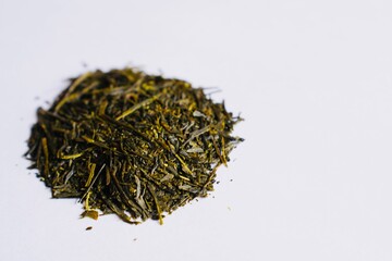 Green tea leaves on white