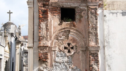 Damaged plaster over brick on a tomb in La Recoleta Cemetery in Buenos Aires, Argentina