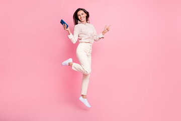 Full length photo of lady jump use smart gadget point empty space promo ads isolated on pastel...