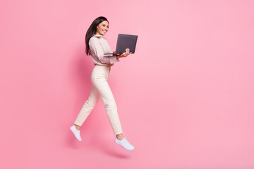 Full length photo of lady manager jump using netbook searching discounts isolated on pastel color background