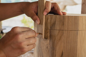 wood craftsman using the pencil marking make on the wooden box product working at carpentry...