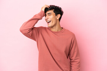 Young Argentinian man isolated on pink background has realized something and intending the solution