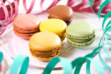 Close-up of macarons cakes of different pastel colors in white background. Culinary and cooking concept. Tasty colourful macaroons