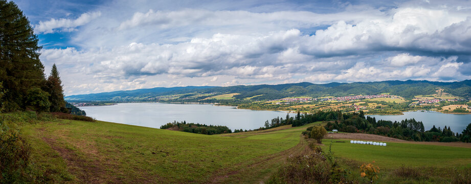 Panoramic view at Czorsztynskie Lake and Gorce Mountains seen from bicycle route Velo Czorsztyn, leading through the hills surrounding the lake. Beautiful, late-summer scenery.