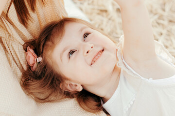 Little girl having fun with big sister. Close up portrait, smiling face.