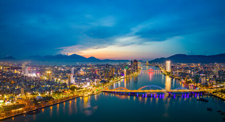 Fototapeta premium Aerial view of Dragon Bridge at sunset which is a very famous destination of Da Nang city.