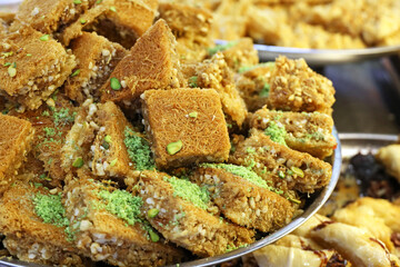 Baklava with pistachios and peanuts, sweet background. Traditional turkish and arabic dessert Kunafa with pistachio, nuts and honey