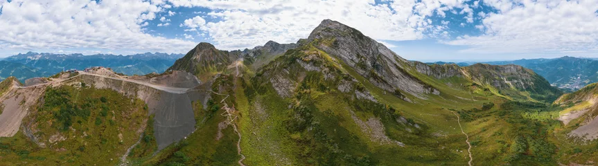 Fotobehang Alpine Meadows Trail, Krasnaya Polyana Resort. Alpine Meadows Walking Route. Aerial view of the green mountain valley, surrounded by high mountains. © Quatrox Production
