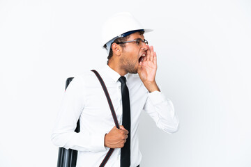 Architect brazilian man with helmet and holding blueprints shouting with mouth wide open to the side