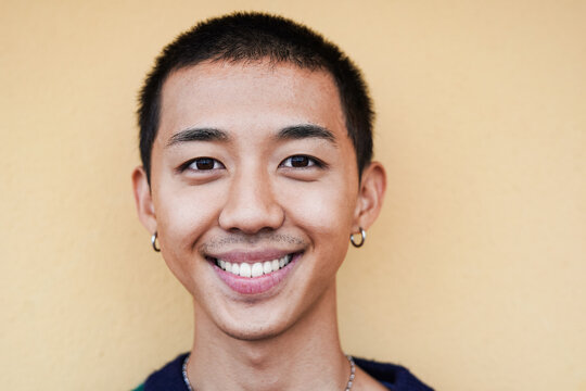 Young asian man smiling on camera