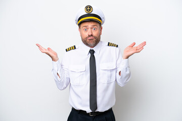 Airplane middle age pilot isolated on white background having doubts while raising hands