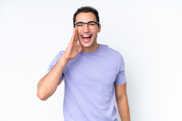 Fototapeta premium Young caucasian man isolated on white background shouting with mouth wide open