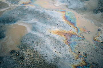 Fototapeta na wymiar Dirty multi-colored stain from engine oil on asphalt