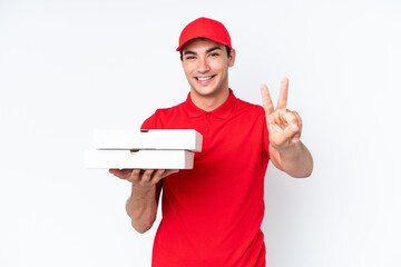 Pizza delivery caucasian man with work uniform picking up pizza boxes isolated on white background...